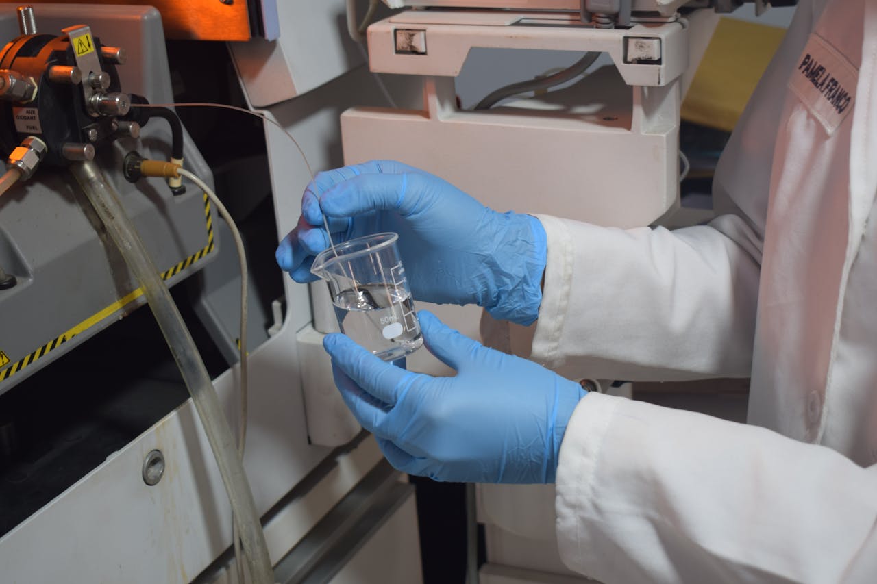 Close-up of a scientist handling a beaker with precision in a laboratory setting.