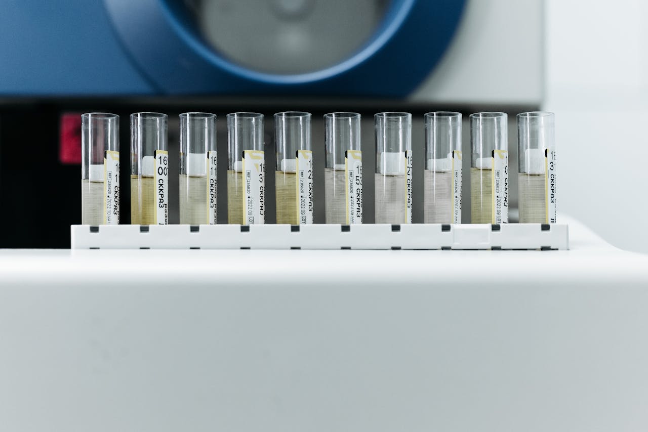 Row of labeled test tubes on a rack in a modern laboratory environment.